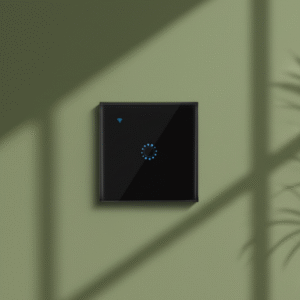 A single black European standard smart touch control console mounted flush on a sophisticated olive green wall. The blue indicator light is illuminated, and subtle, natural shadows from a nearby window or foliage create an inviting and luxurious ambient effect.