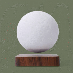 Close-up studio shot of a white, textured spherical lamp (moon replica) levitating magnetically above a square base with a realistic dark wood grain finish, set against a solid olive green background.