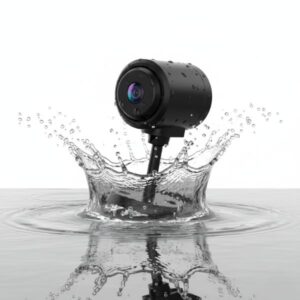 Black mini camera dipping into water, causing a prominent splash and ripples, demonstrating water resistance.