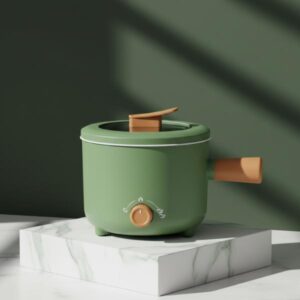 The green electric cooking pot resting on a small white marble block, set against a dark olive green background wall with sharp shadows.