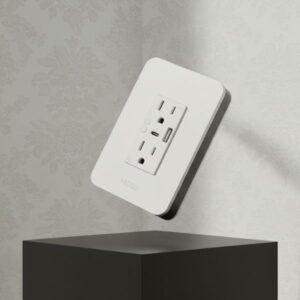 A white smart plug with USB ports is levitating at a 45-degree angle above a matte black block. The background features a white aesthetic wallpaper with subtle patterns.