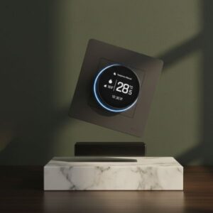 An artistic, tilted view of the smart thermostat hovering above a marble surface against a dark green background, highlighting the sleek side profile and the depth of the device design.