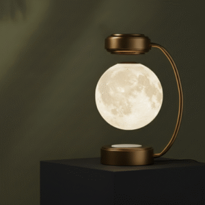 A gold and black levitating moon lamp, suspended over a matte black block pedestal, set against a dark olive green background.