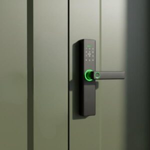 A close-up shot of a black smart door lock, featuring a keypad and a handle with a green-ringed fingerprint sensor, installed on a vertical, dark olive green paneled door.