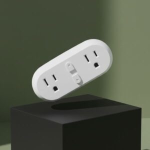 A white, oval-shaped smart power strip is levitating in mid-air at a 45-degree angle above a matte black block. The background is an olive green wall with soft shadows.