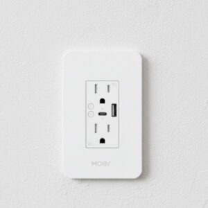 A white smart plug with USB ports is installed flush into a textured white wall, shown in a clean, straightforward view.