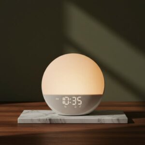 A glowing, spherical smart clock or light sitting on a white and grey marble slab on a dark wooden surface. The device displays. The background is a solid, dark olive-green wall with strong directional shadow.