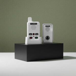 A white doorbell and receiver unit are displayed on a matte black block, set against an olive green wall with soft shadows