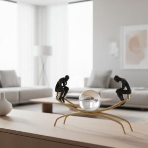 Close-up of the geometric flame-effect diffuser sitting on a white study desk with a laptop and stacked books in the background.