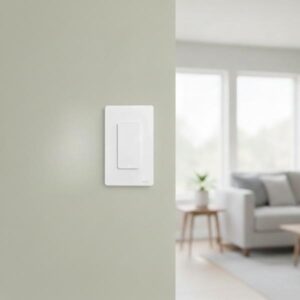 A white one-gang smart switch is installed on a light olive green wall in a blurred modern living room interior